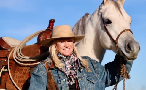 Jo’Ann Montana Cowgirl with horse in landscape
