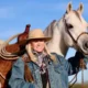 Jo’Ann Montana Cowgirl with horse in landscape