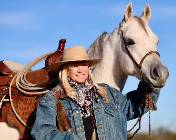 Jo’Ann Montana Cowgirl with horse in landscape