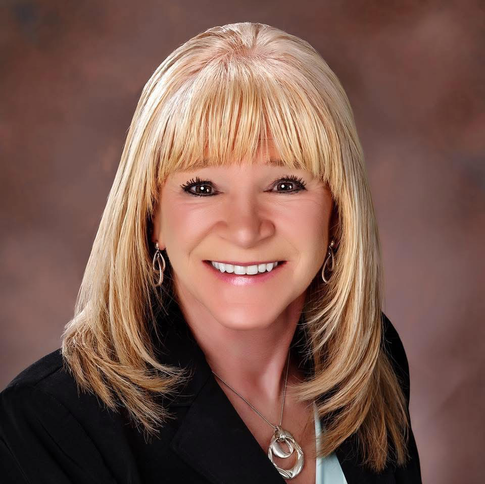 Jo’Ann Montana with blonde hair and necklace